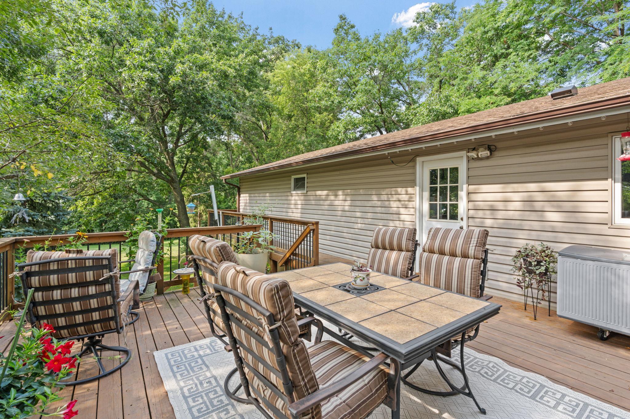 A beautiful deck in great condition overlooks the backyard and wraps around to the garage and driveway, adding extra convenience.
