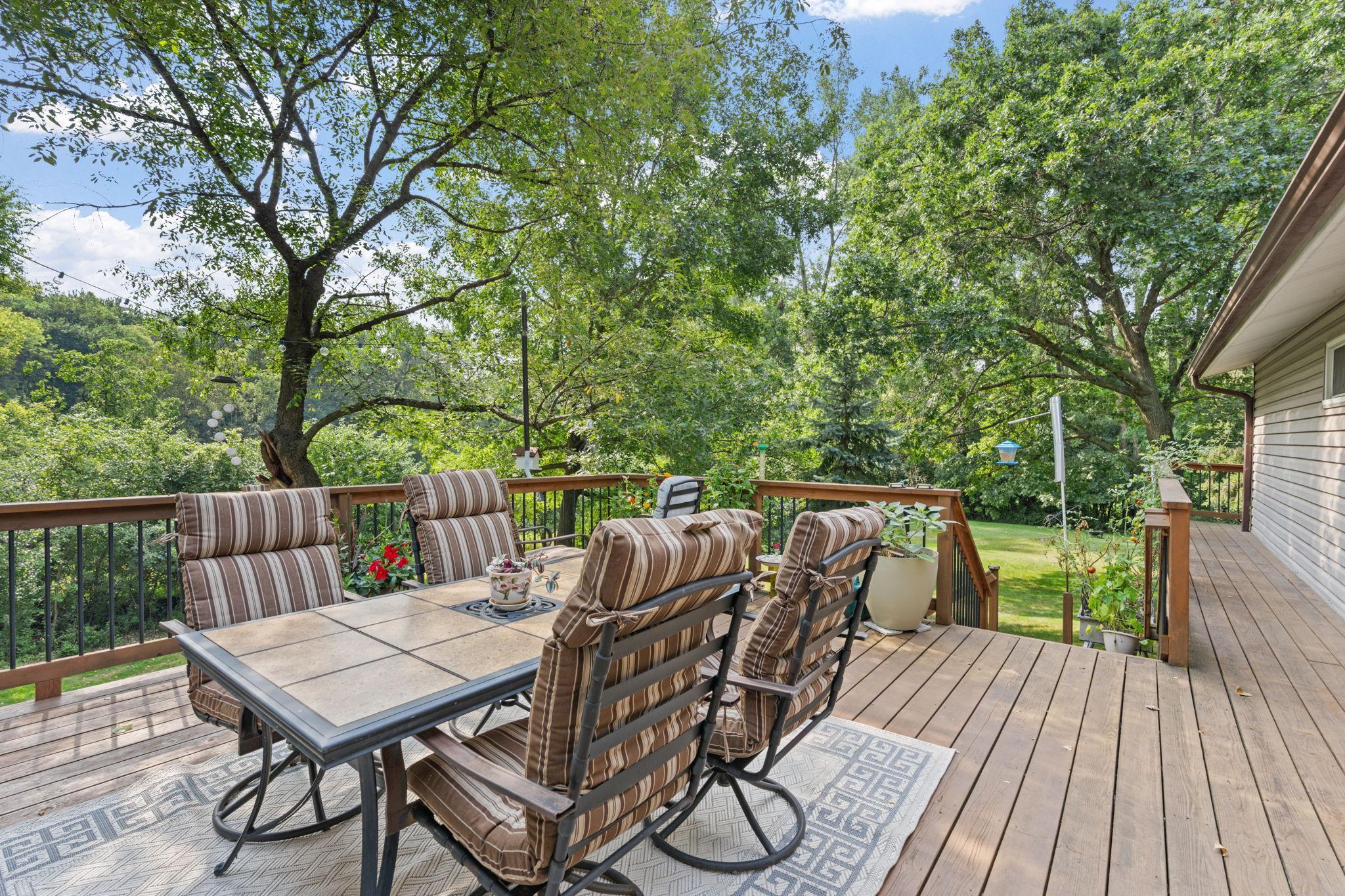 A beautiful deck in great condition overlooks the backyard and wraps around to the garage and driveway, adding extra convenience.