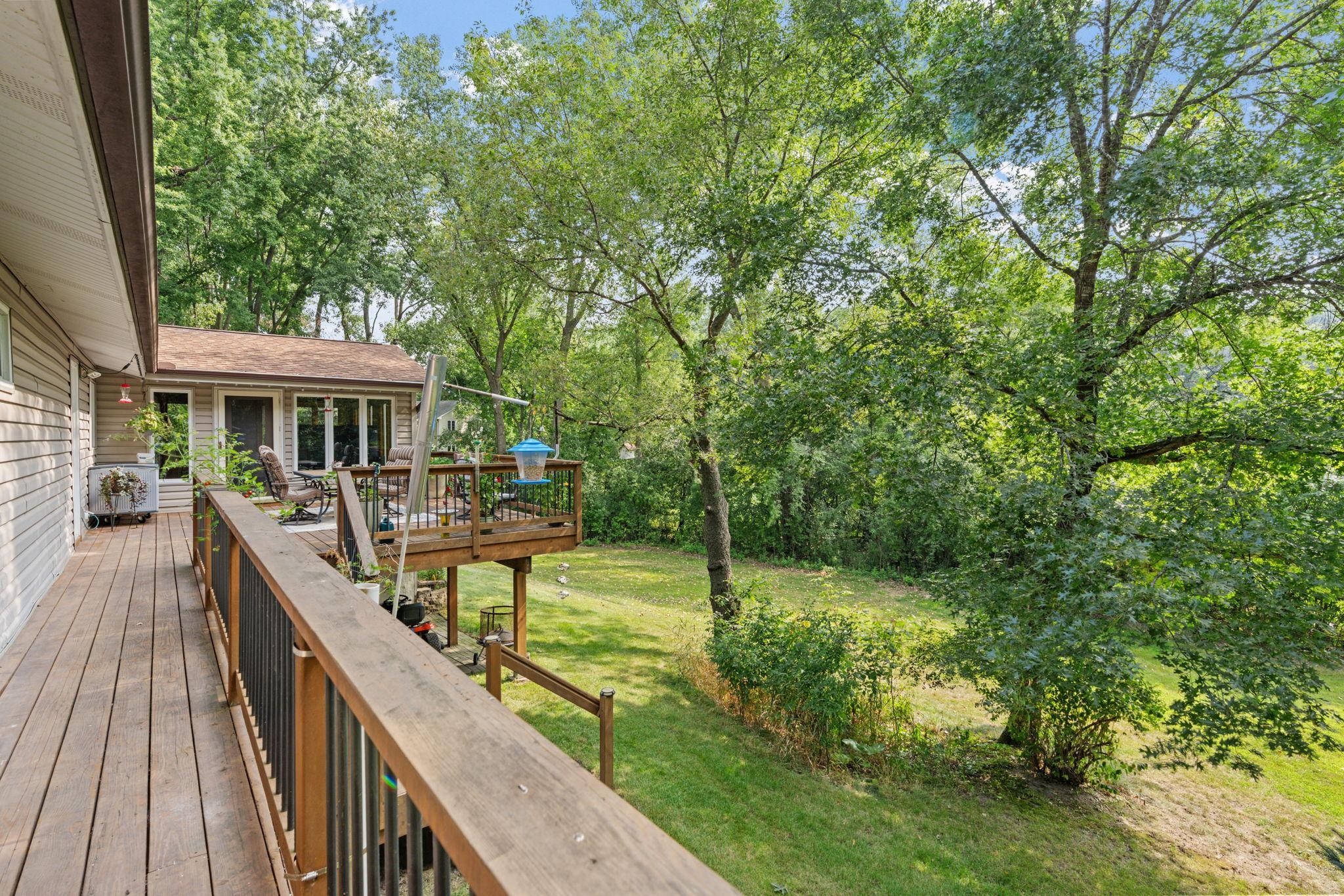A beautiful deck in great condition overlooks the backyard and wraps around to the garage and driveway, adding extra convenience.