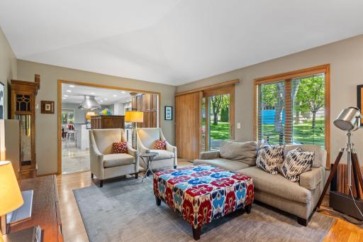 The family room is a favorite spot in the home with hardwood flooring, vaulted ceilings, and oversized windows overlooking the backyard and greenspace.