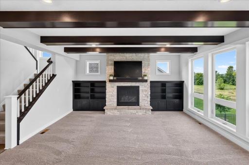 Beams and stone to the ceiling gas fireplace w/custom built-ins make this a true gathering place.
