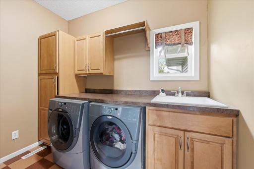 Conveniently located laundry area with practical storage and workspace.