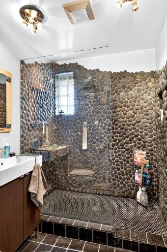 walk in shower with double shower heads and heated floors