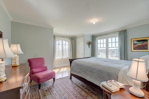 The second upper-level bedroom offers two spacious closets and peaceful viewsâcombining comfort and functionality