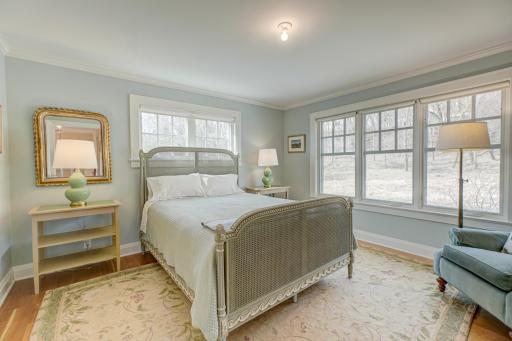 Escape to this serene primary suite, where privacy and picturesque nature views create the perfect place to unwind
