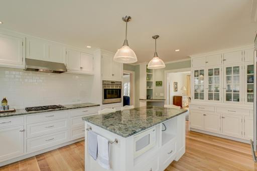 The heart of the home shines hereâfeaturing granite counters, stainless steel appliances, a spacious island ideal for gathering, and a large built-in providing incredible cabinet space