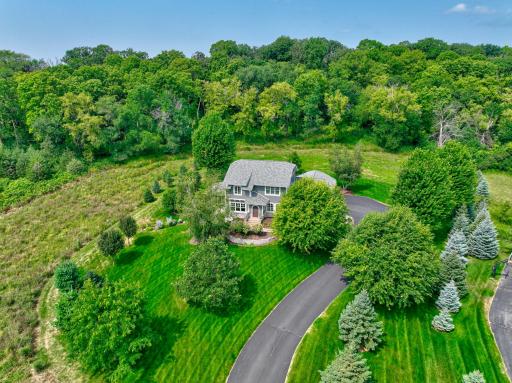 Welcome to 2156 Paris Ave N, perfectly situated on a gentle grassy rise with a wooded backdrop for supreme privacy!