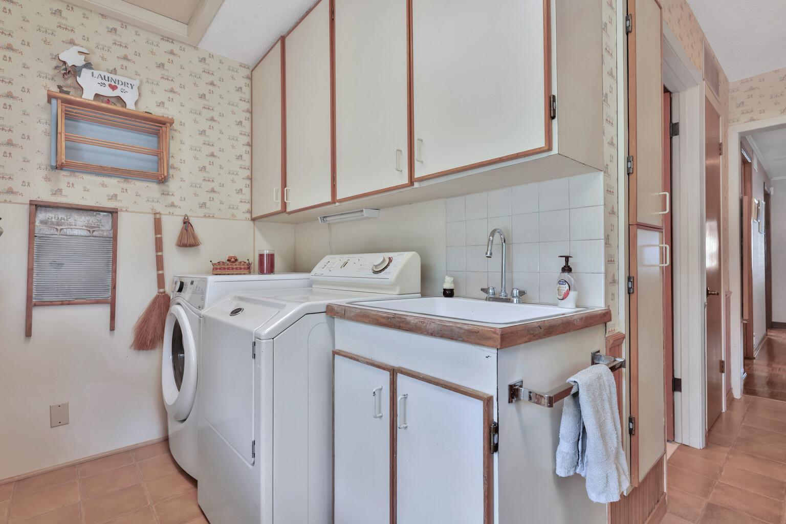 Laundry area with ample cabinetrty.