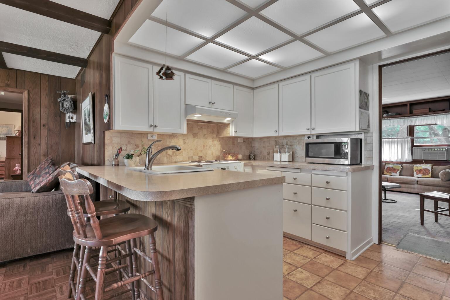 Compact kitchen area with ample lighting.