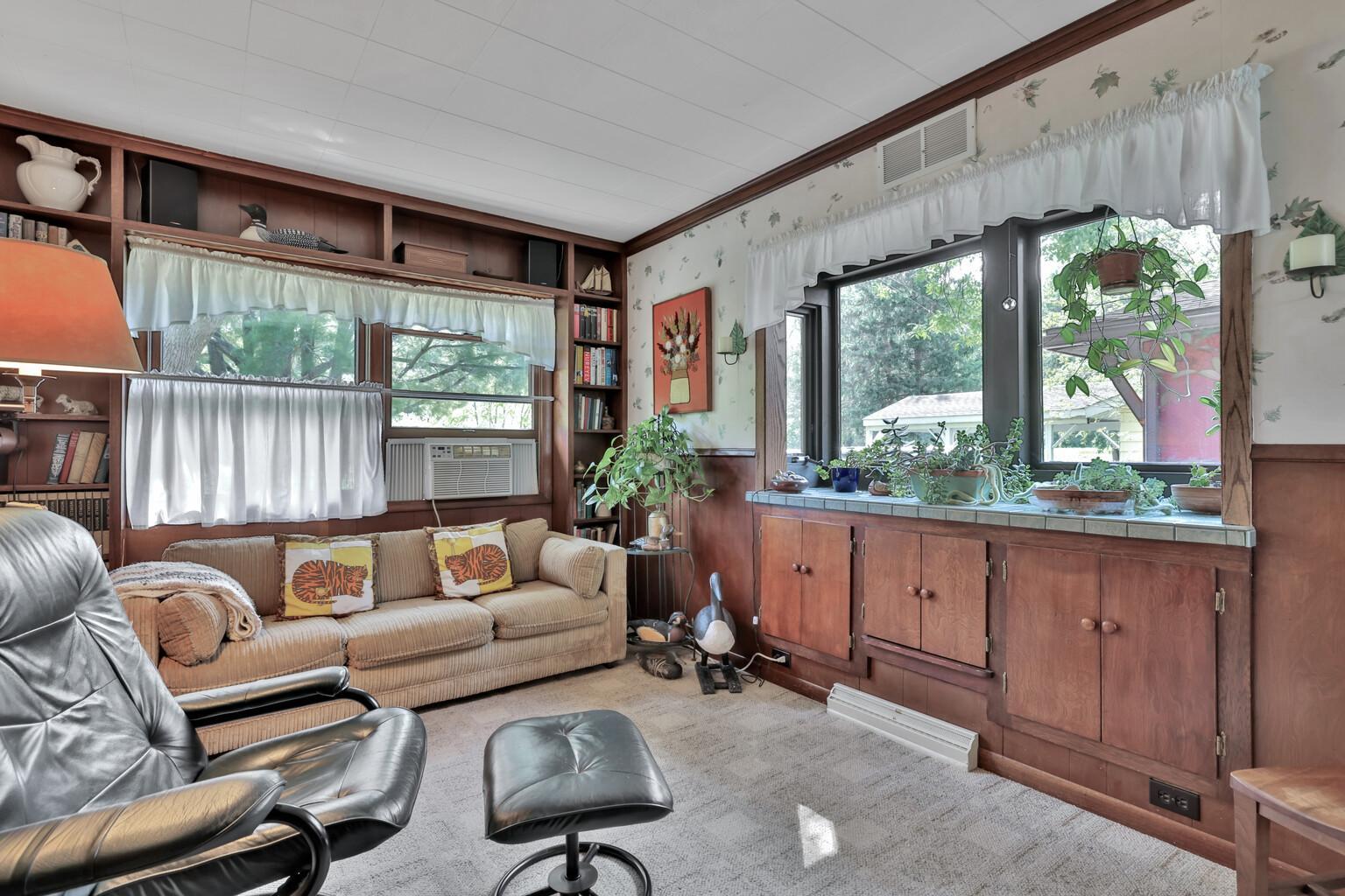 Den with ample cupboard space.