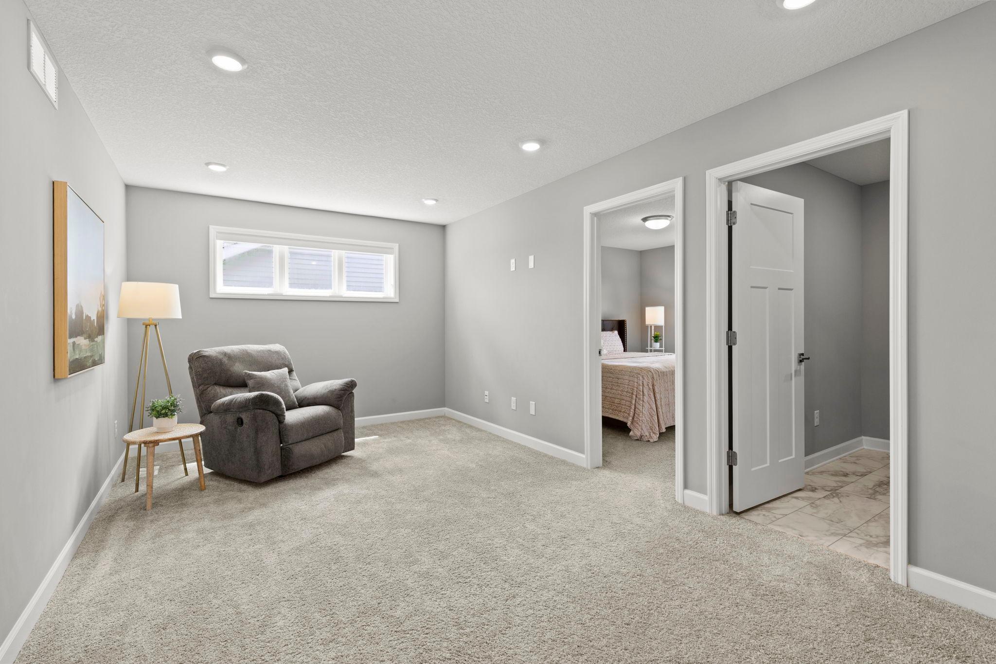The upper level also features a centrally located loft, providing the perfect space for a second living area, media room, or home office.