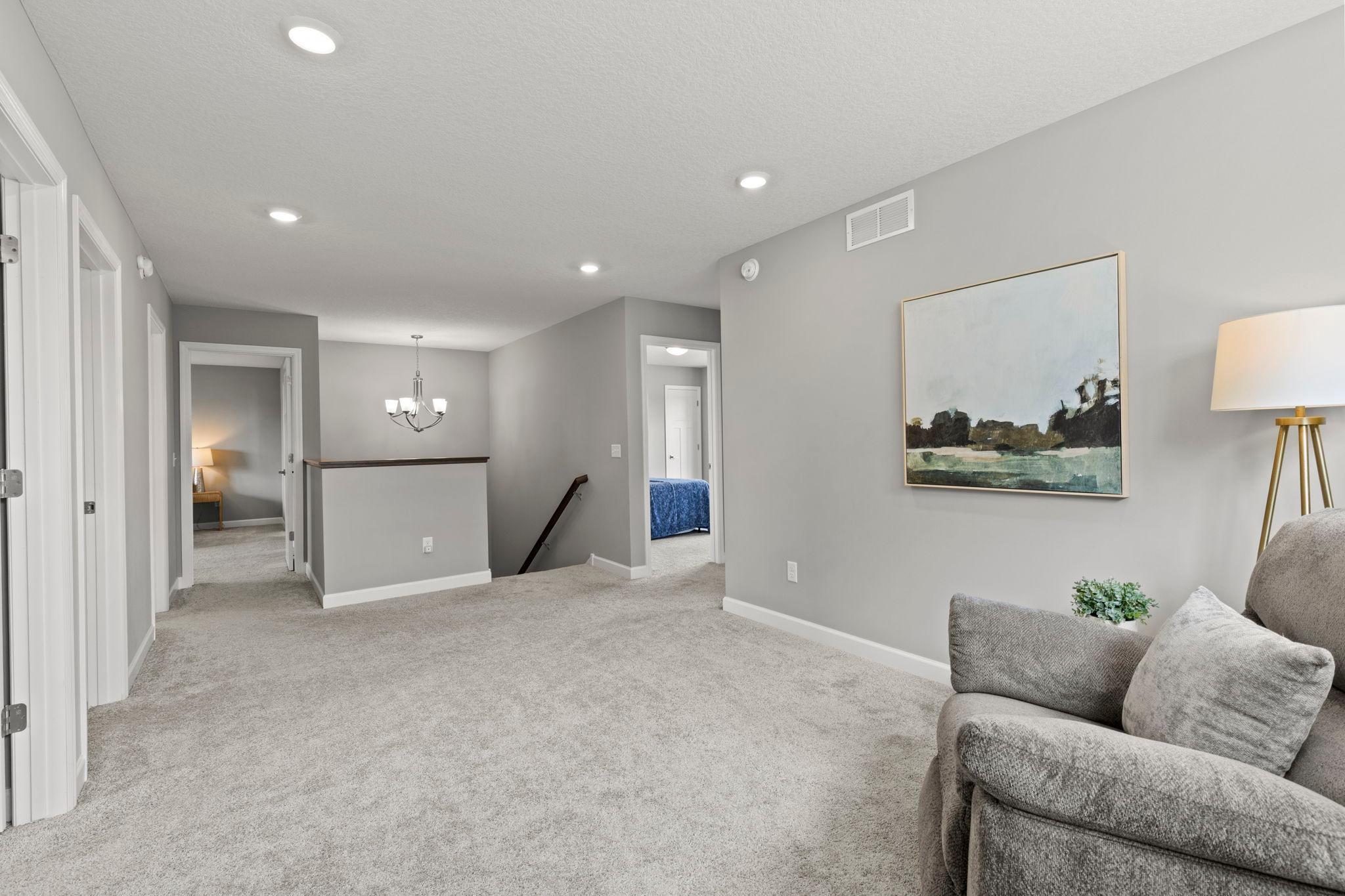 A different view of the upper-level loft and surrounding rooms.