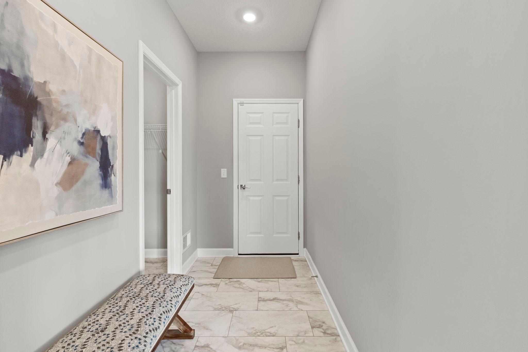 Completing the main level is a practical mudroom entry from the attached insulated two-car garage, highlighted by an additional 5' x 4' walk-in closet that serves as the perfect drop zone for coats, shoes, and everyday essentials.