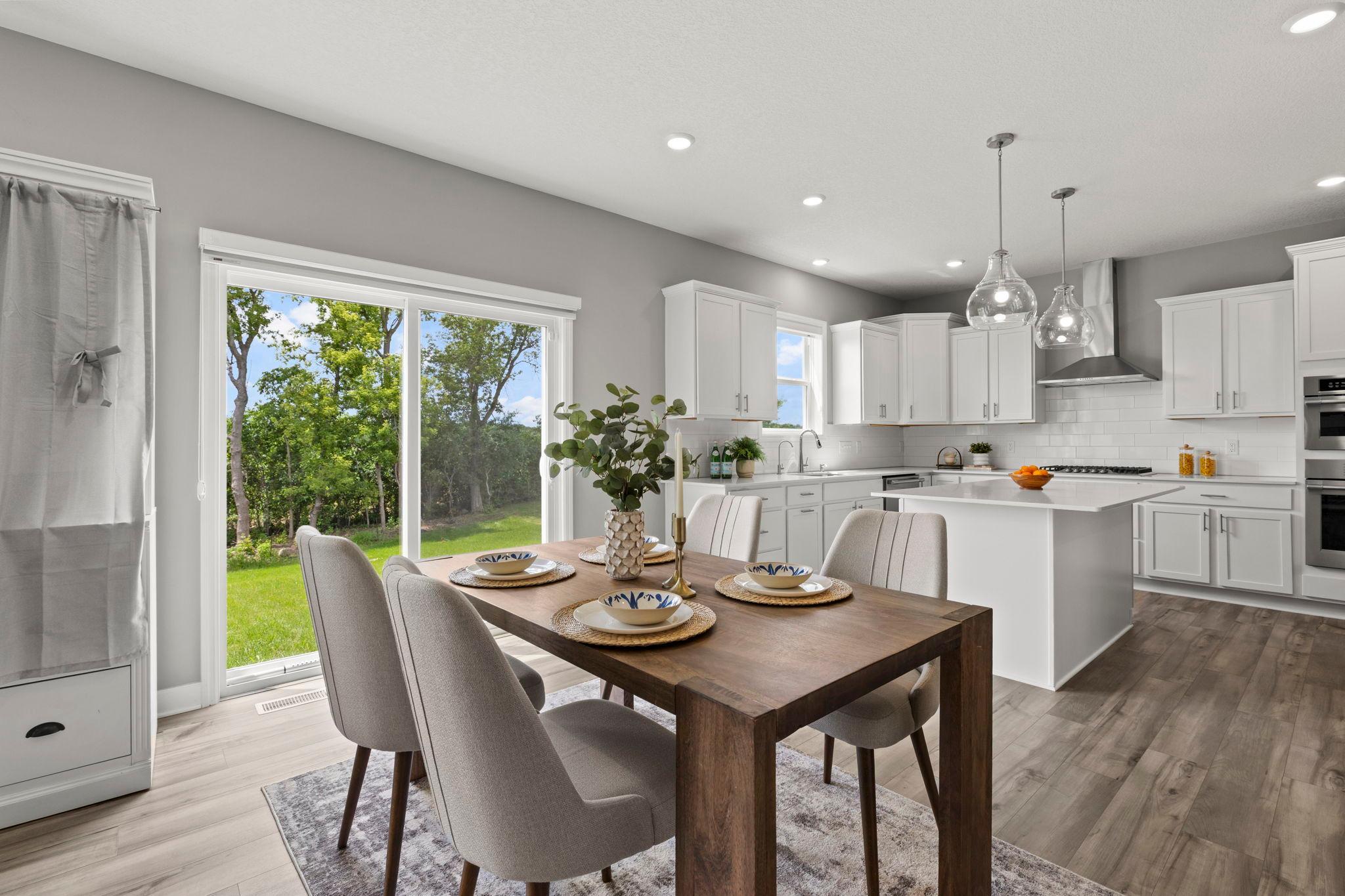 The kitchen flows effortlessly into the informal dining area, complete with sliding glass doors leading to the backyard—ideal for indoor-outdoor entertaining.