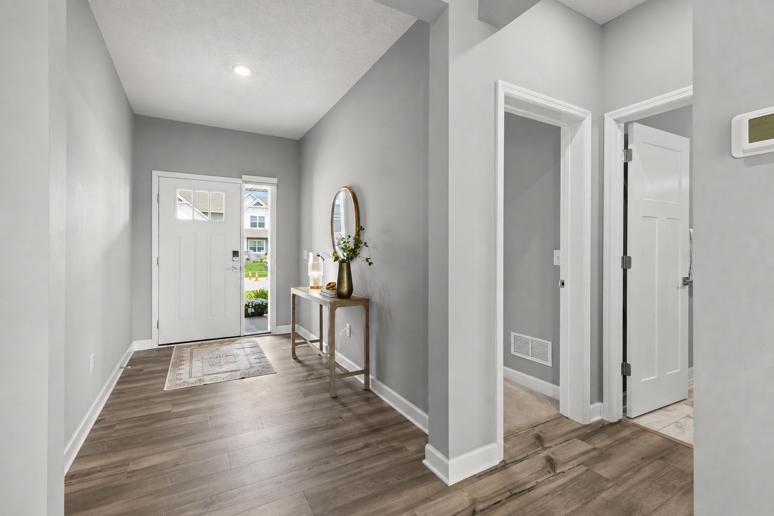 Step inside to an inviting open-concept floor plan featuring luxury plank flooring throughout the main level.