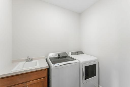 Laundry room is on the main level near the mudroom and features a laundry sink with cabinet! Washer/dryer are also included with the home.