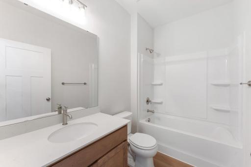 Upstairs bath includes a shower/tub combo and is shared by the two upstairs bedrooms. Photo of model home; Options and finishes may vary.