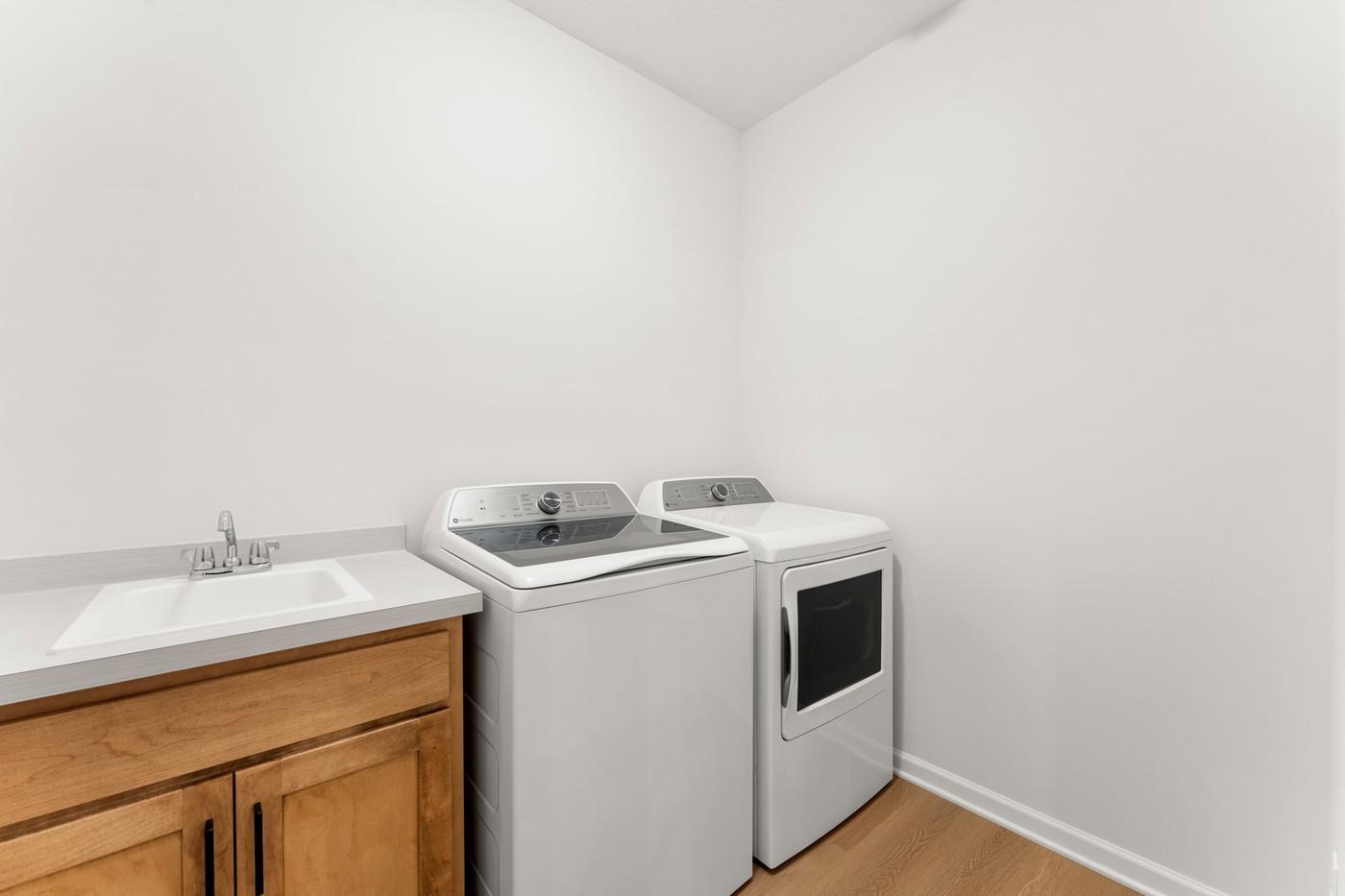 Main level laundry with laundry sink/cabinet - Washer & Dryer by GE are included!