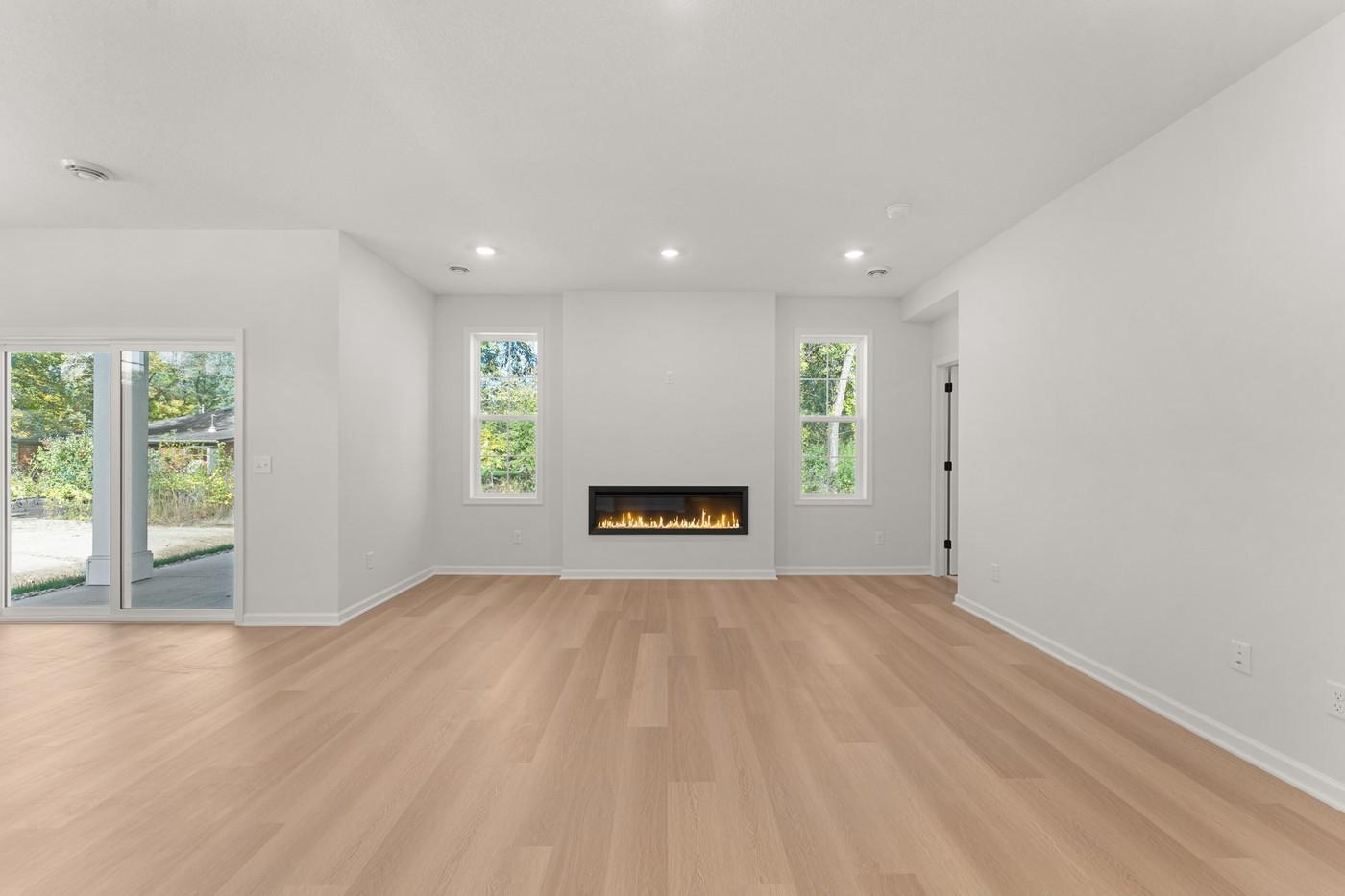Family Room w/ electric fireplace - Enjoy views of your wooded backyard!