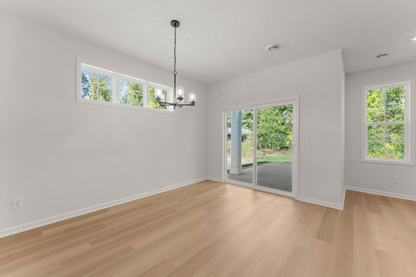 Dining Area and sliding glass door to patio! Home backs to mature trees.