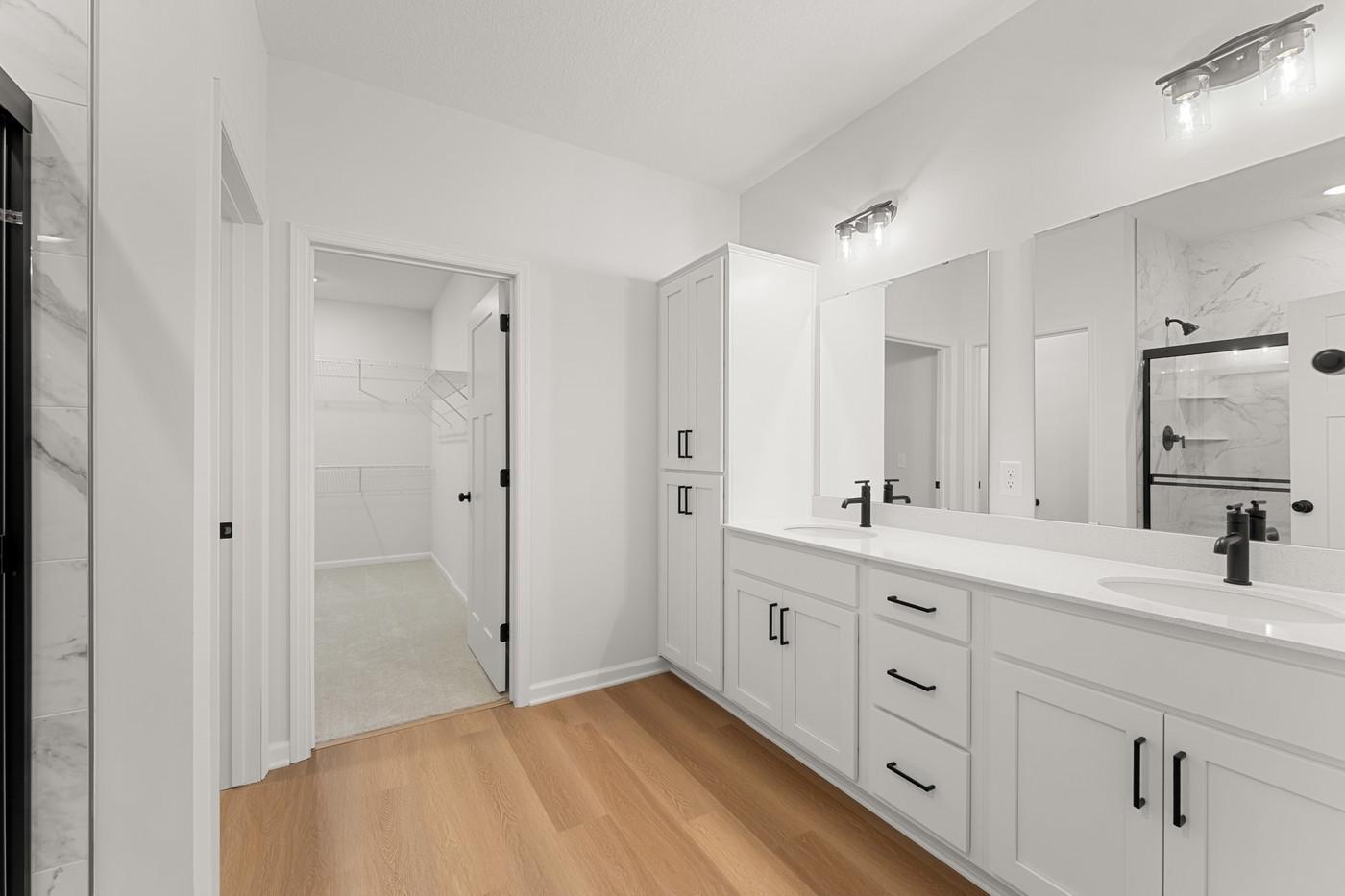Owner's Bath - Dual sinks, quartz countertops, tiled shower, enclosed water closet and large walk-in closet!