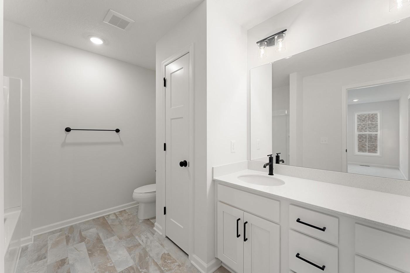 Upper level full bath with shower/tub combo and lots of storage and countertop space!