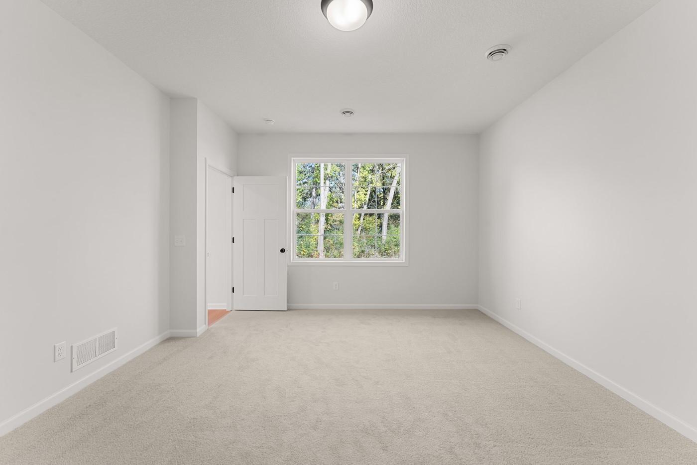 Owner's Suite with view of wooded backyard