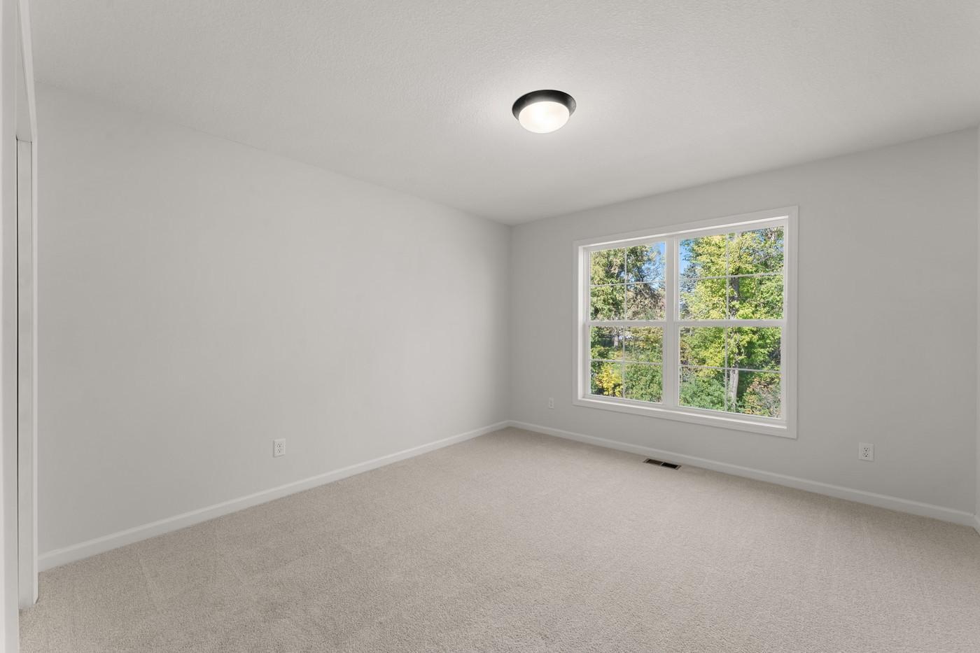 Second upper level bedroom, also overlooking the backyard