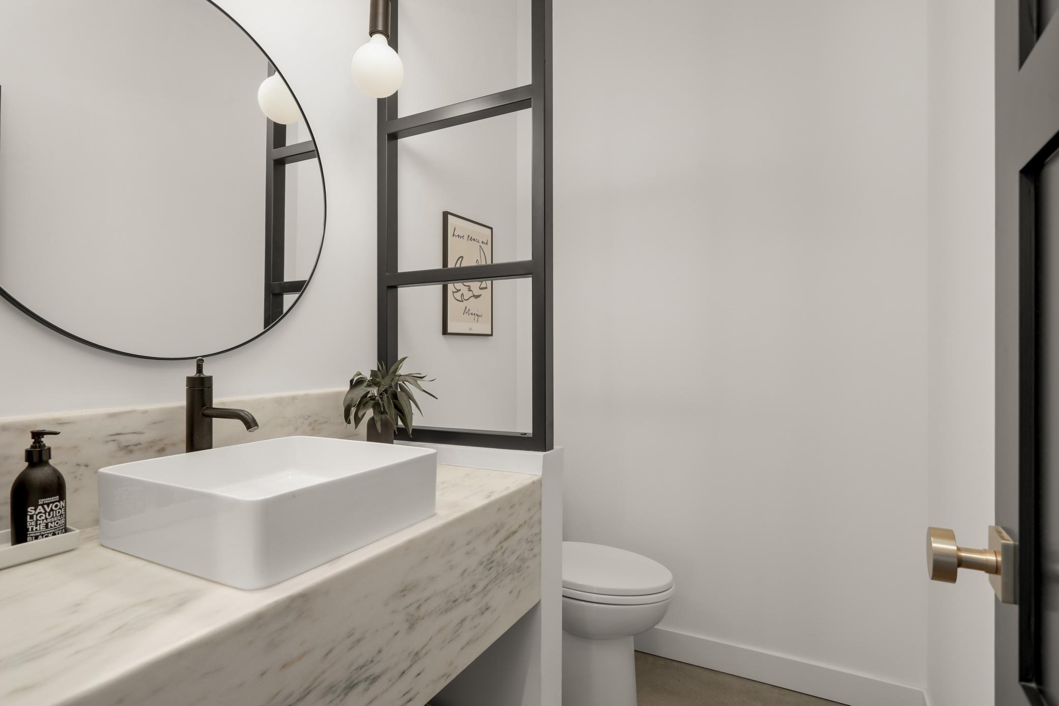 Powder bath with custom glass divider and 24 inch Danbury marble counter....