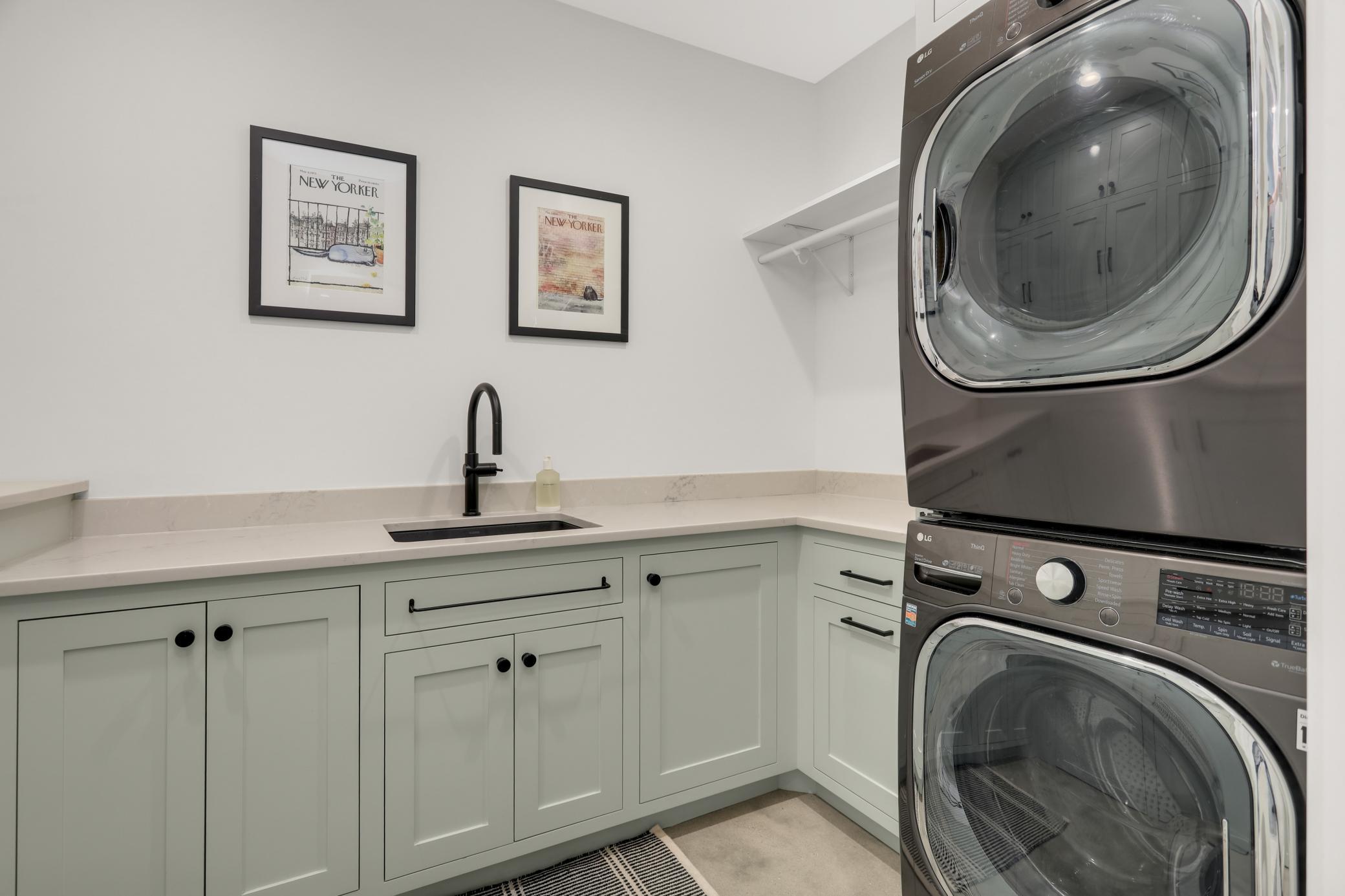 Laundry room with sink, ample counter space & an impressive amount of storage