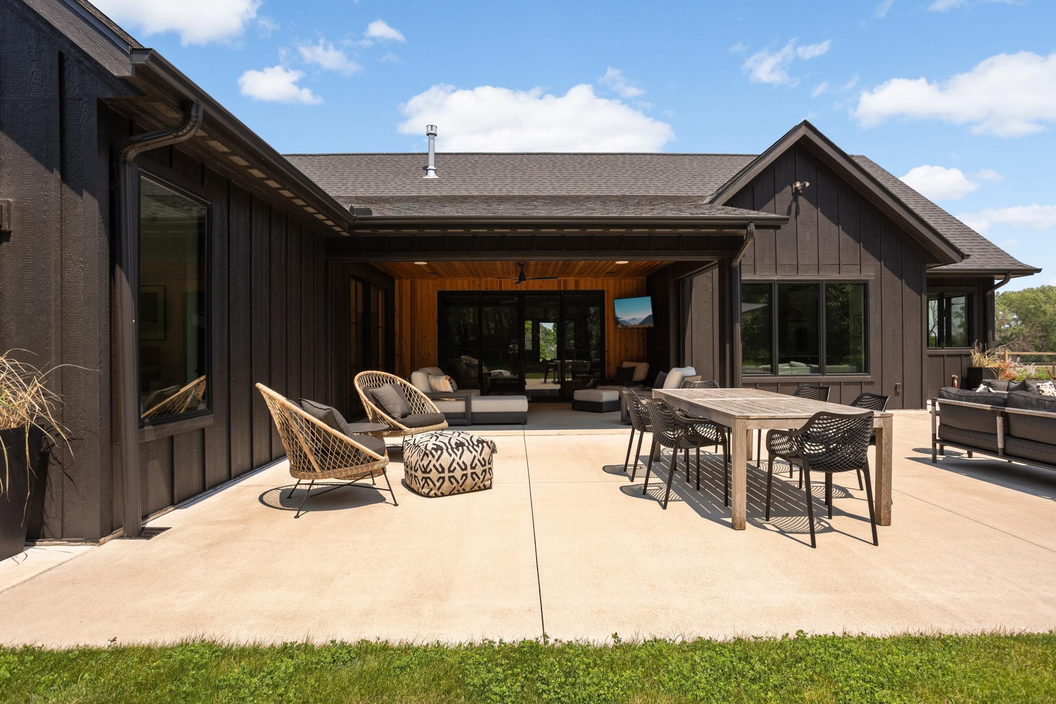 Huge concrete patio offers plenty of seasonal entertaining. Covered patio with remote controlled phantom screens extends the seasonal living space