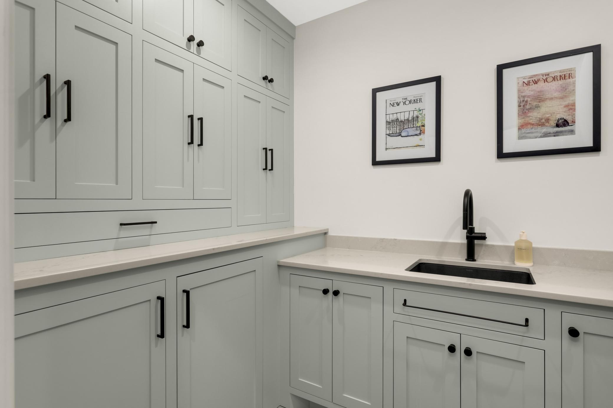 Custom cabinetry offers massive storage in the laundry room