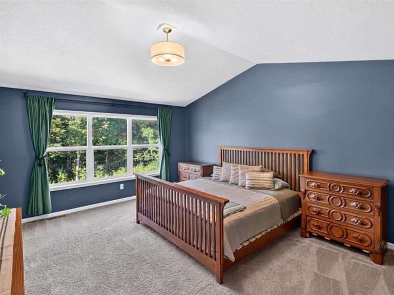 Entering the master bedroom, beautiful view of trees out from the bedroom window.