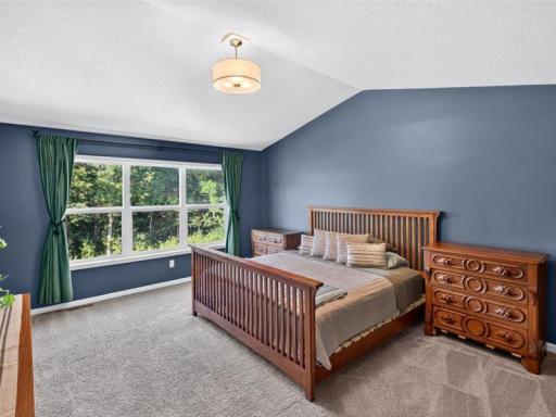 Entering the master bedroom, beautiful view of trees out from the bedroom window.