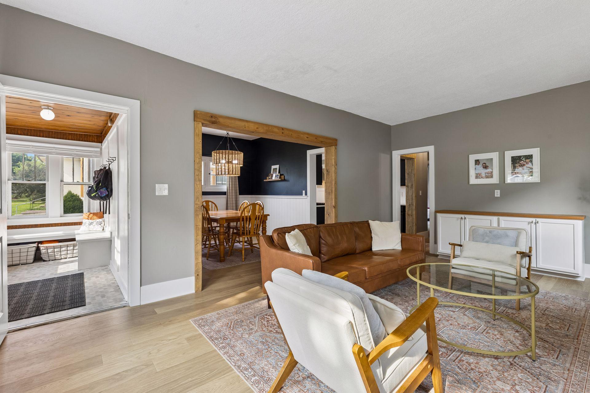 Cute front porch, living room, and adjoining dining room
