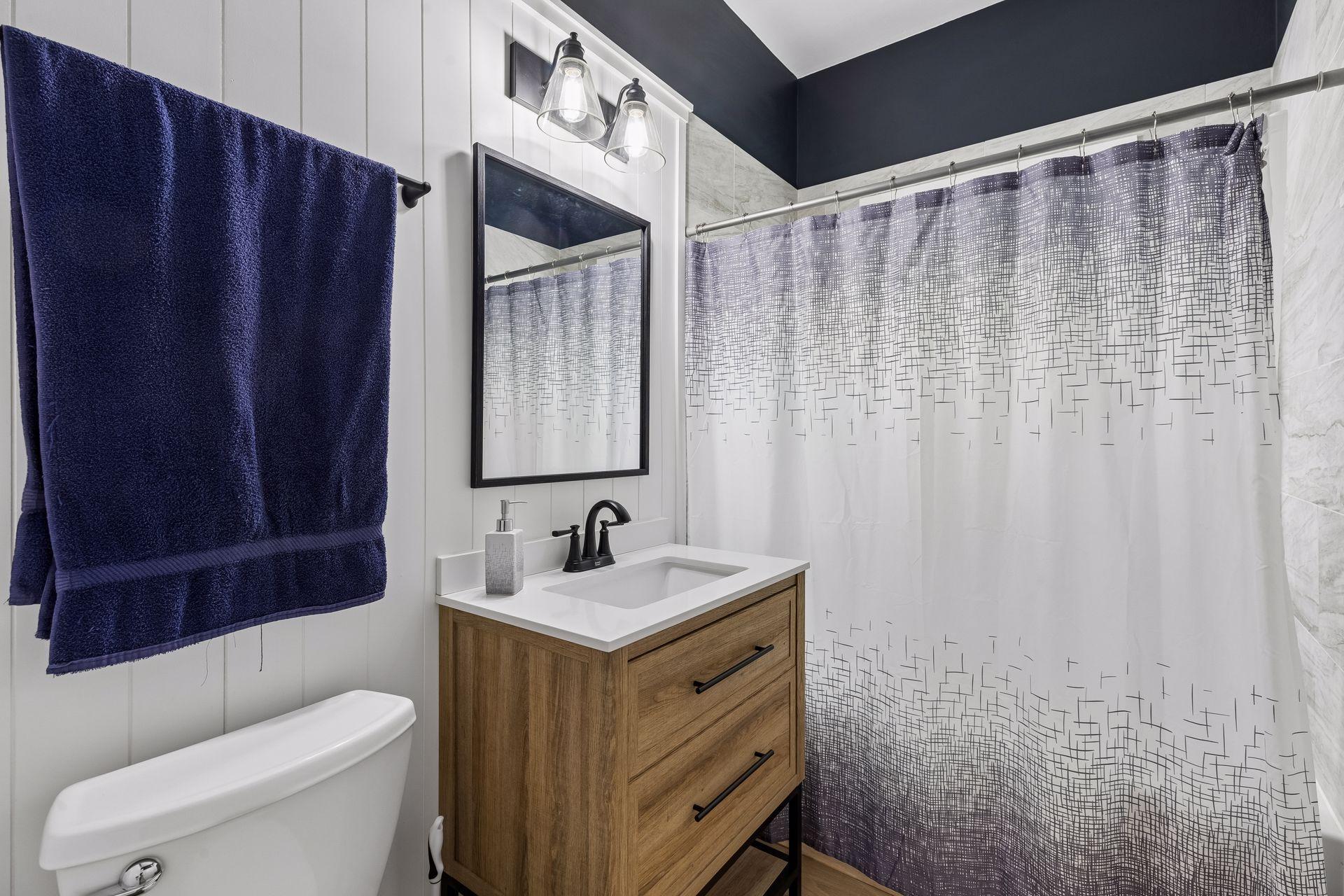 Full bathroom across from the kitchen, next to the two main level bedrooms