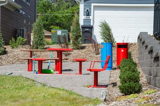 Benches and tables in the corner of the green space