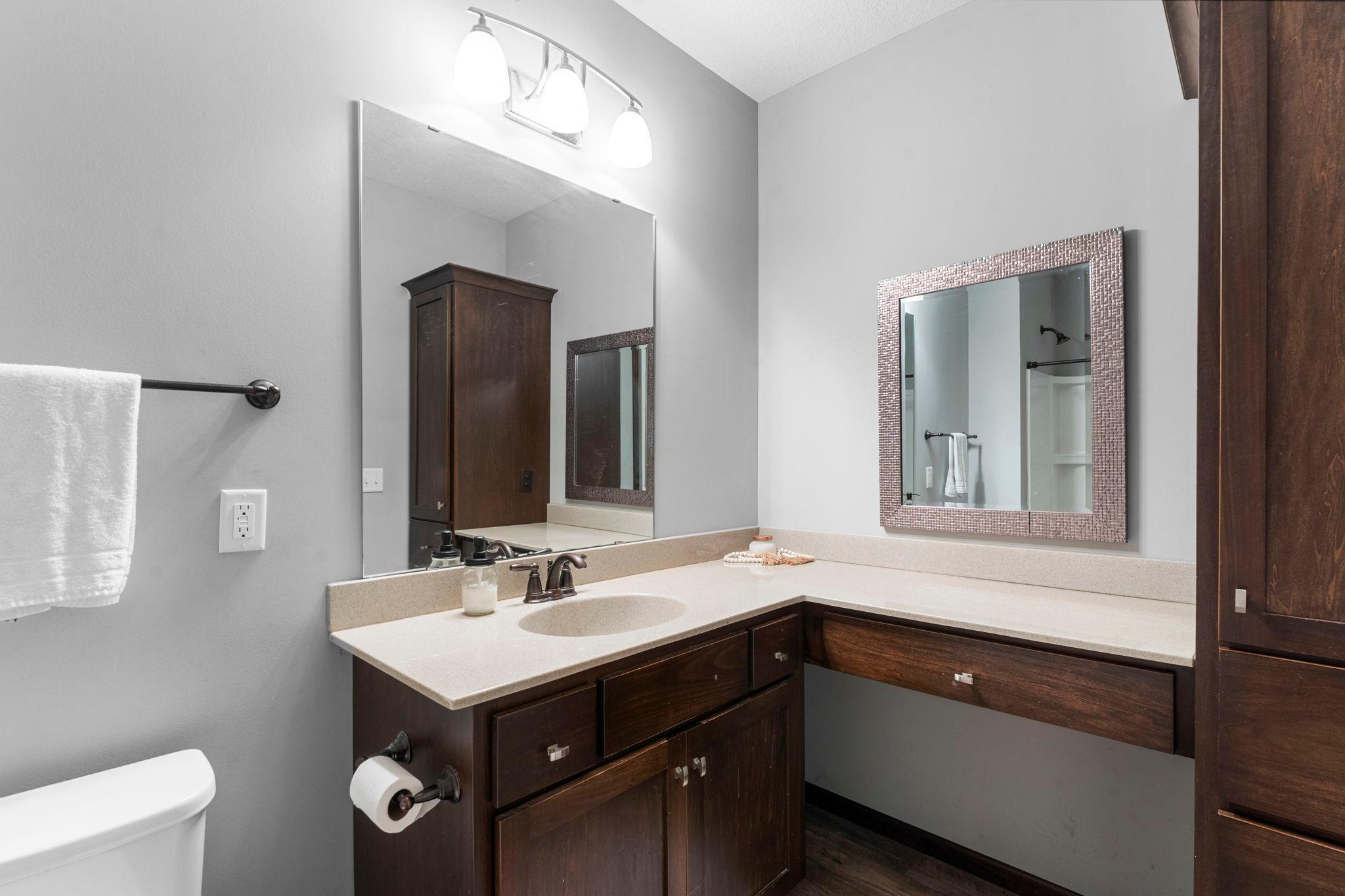 Just steps away is a convenient full bathroom featuring an oversized single vanity and tub/shower combination.