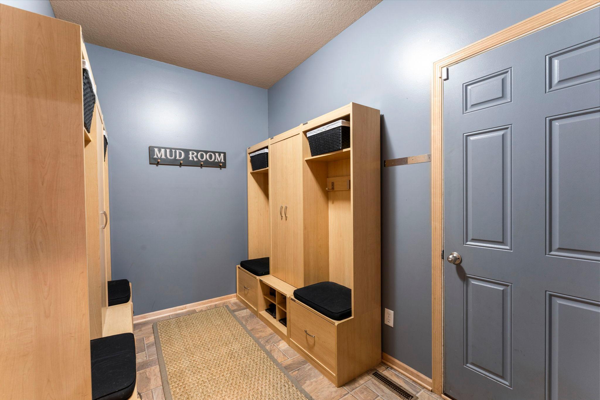 The level is completed by a spacious mudroom with built-in benches, hooks, and storage, along with access to the insulated three-car garage.