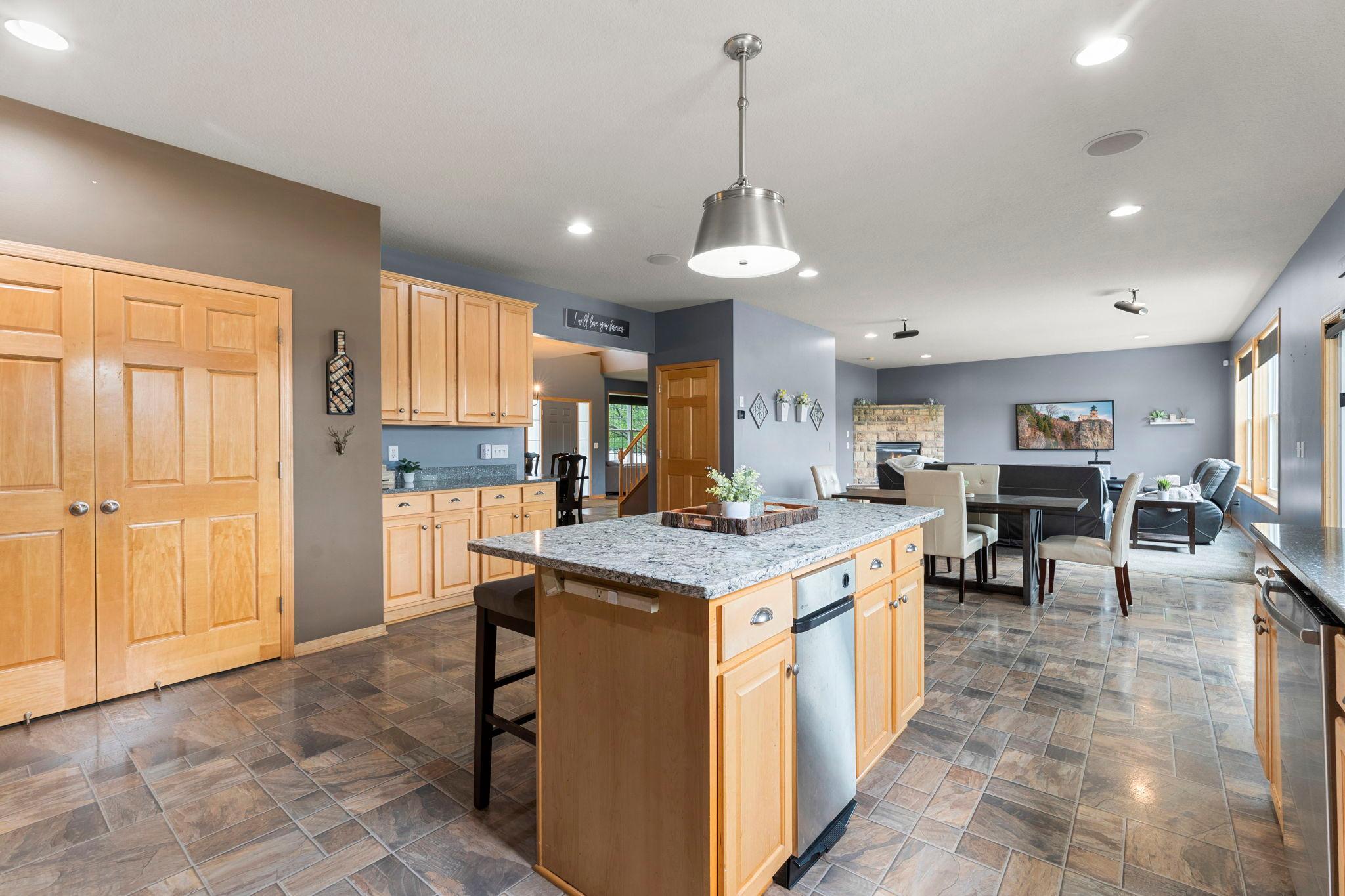 An alternate view of the kitchen showcasing the nearby dining area and living room.