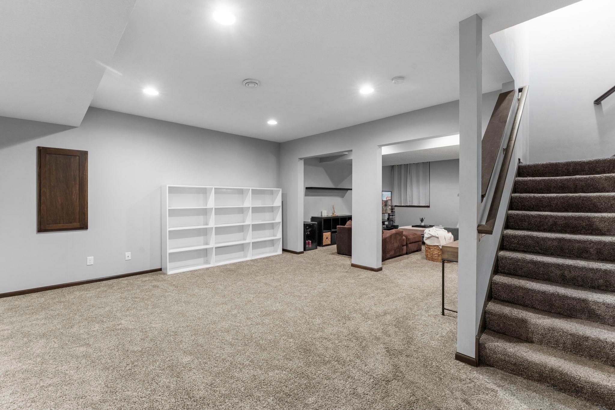 The finished lower level offers even more living space with a large carpeted family room and recreation area.