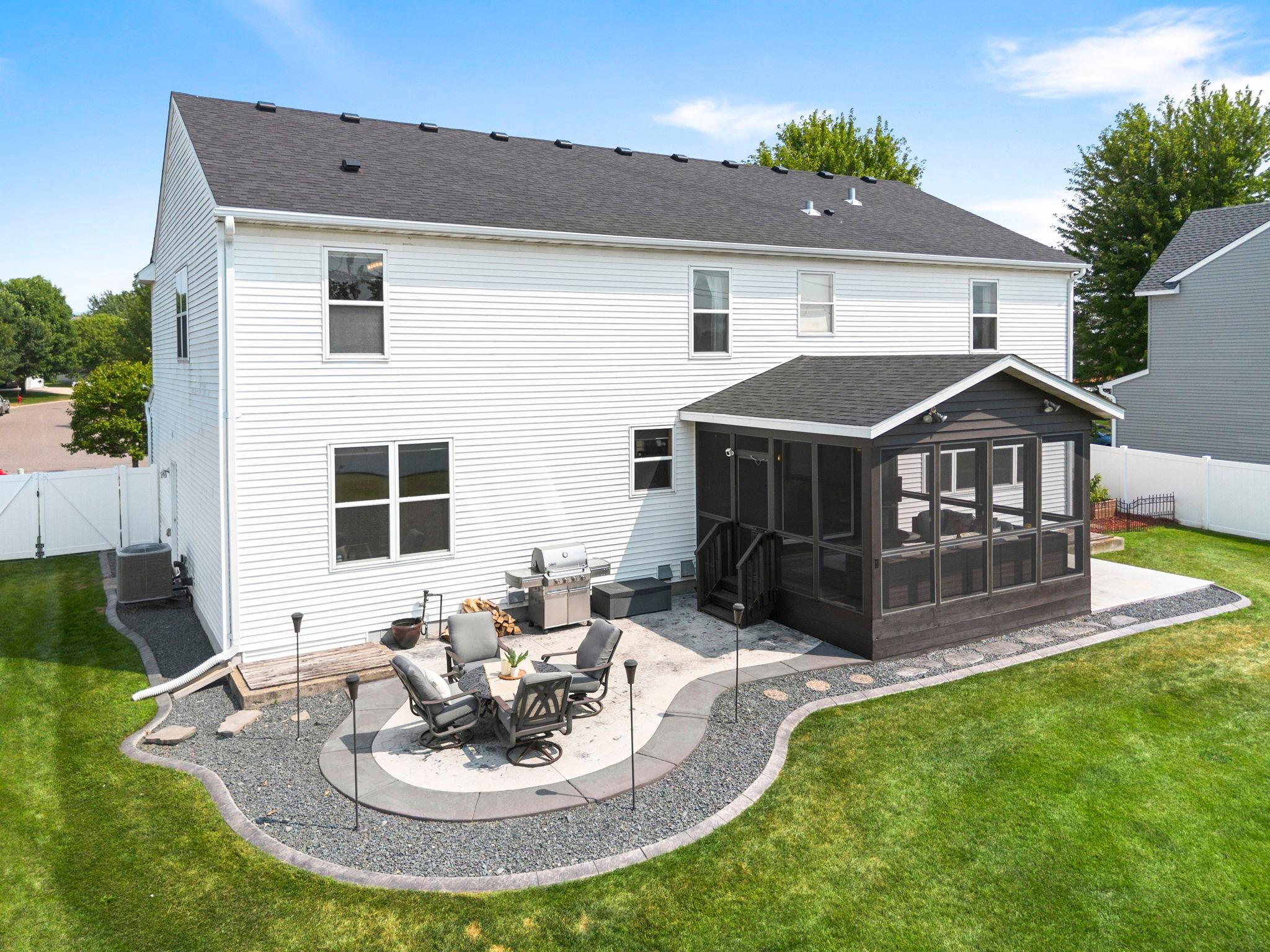 The stamped patio and poured cement slab along the back of the home create the ideal space for outdoor entertaining, relaxing, and enjoying the backyard.