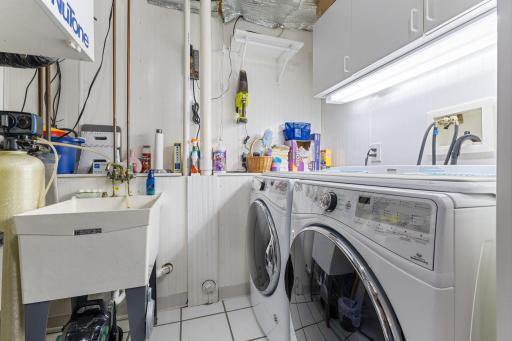 Convenient laundry area with utility sink.
