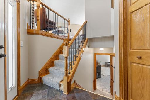 Welcoming split-level entry with warm wood accents and an open view to both levels of the home.
