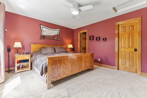 The primary bedroom offers a ceiling fan for added comfort and generous space for a complete bedroom set.