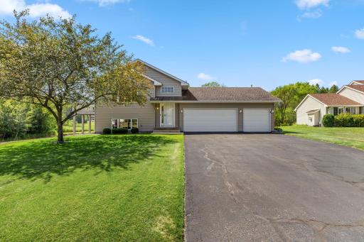 Spacious driveway and an attached three-car garage with room for guest parking.