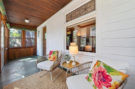 A very inviting front porch with original beadboard ceilings and stained & leaded glass windows