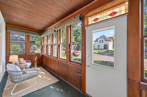 A gorgeous stained glass window adds a pop of color and fun while on the porch and via curb appeal. The front porch provides plenty of space to create a sitiing area to be used as an extension of the home.
