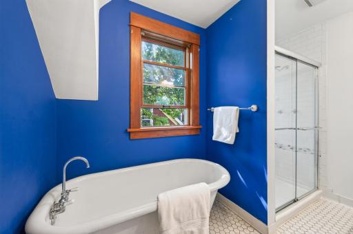 Second floor full bathroom with a soaking tub and step in shower stall with beautiful, neutral tile