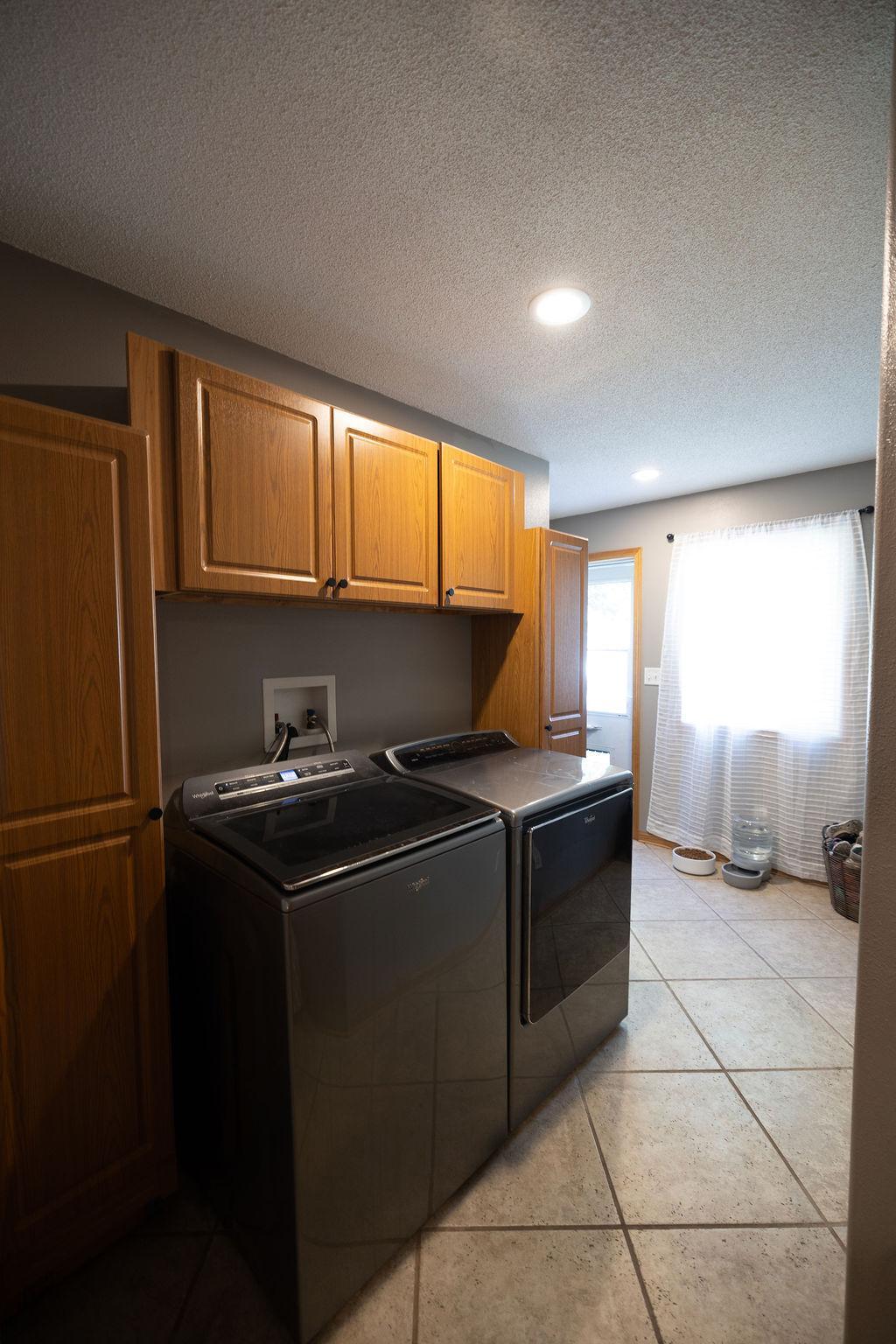 Main floor laundry with cabinet space for convenience
